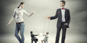 Image of man and woman with marionette puppets